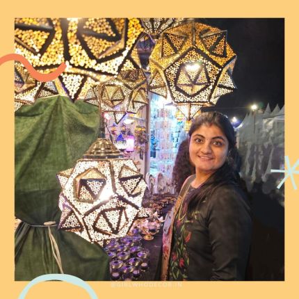 Geetika from GirlWhoDecor at Indian craft market surrounded by jaali metal lanterns tealight holders and decorative home lighting